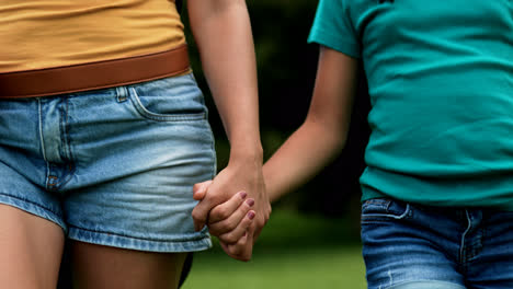 Woman-and-girl-walking-on-grass